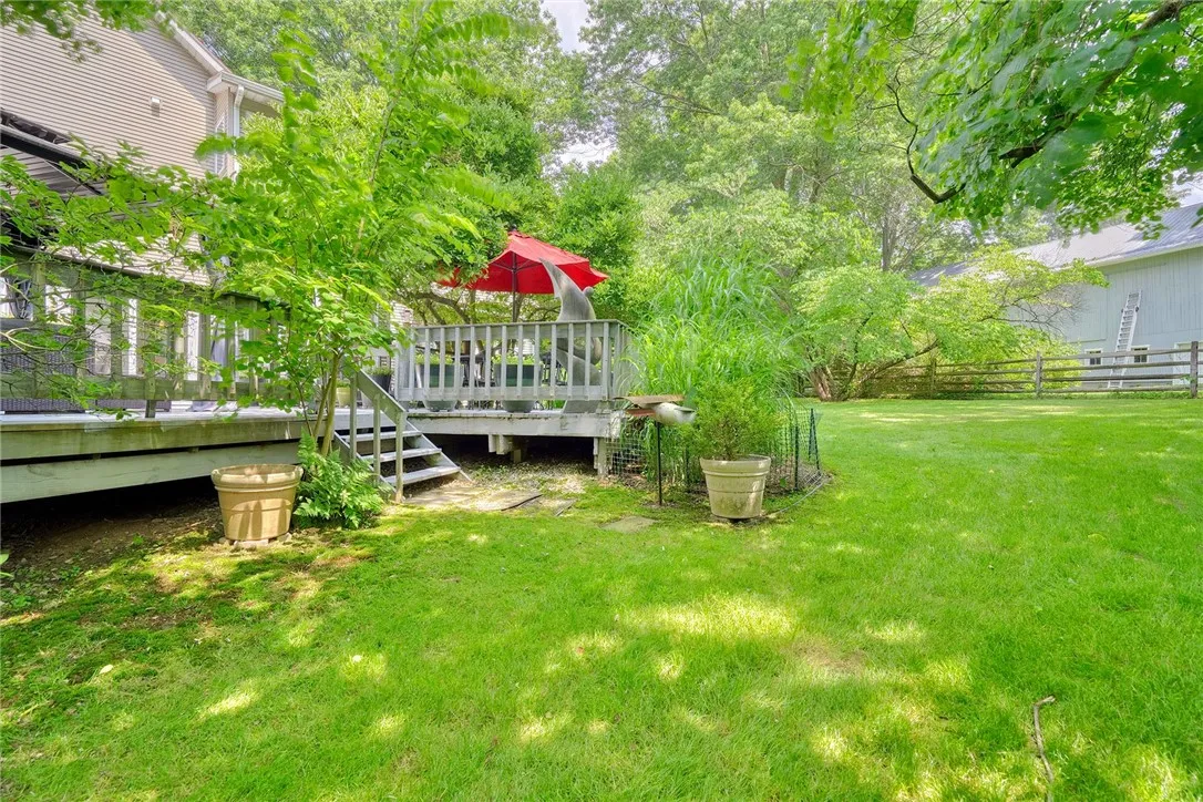 Spacious deck is an outdoor sanctuary surrounded by mature trees & Landscaping. FULLY FENCED BACKYARD with separate gravel and grass pet zones.