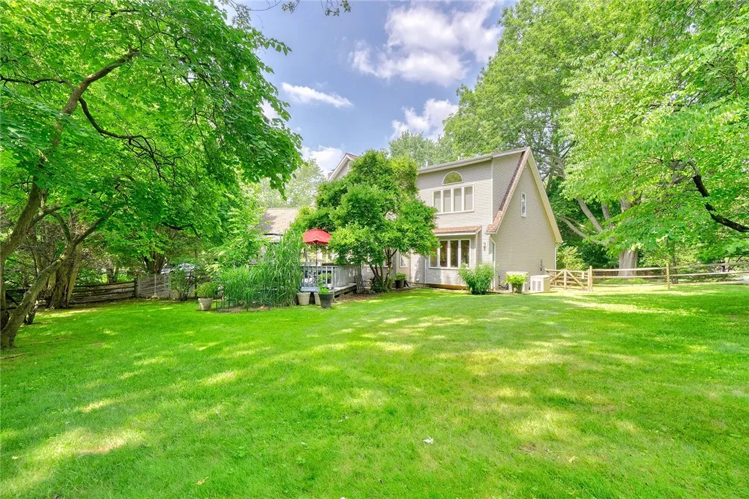 Spacious deck is an outdoor sanctuary surrounded by mature trees & Landscaping. FULLY FENCED BACKYARD with separate gravel and grass pet zones.