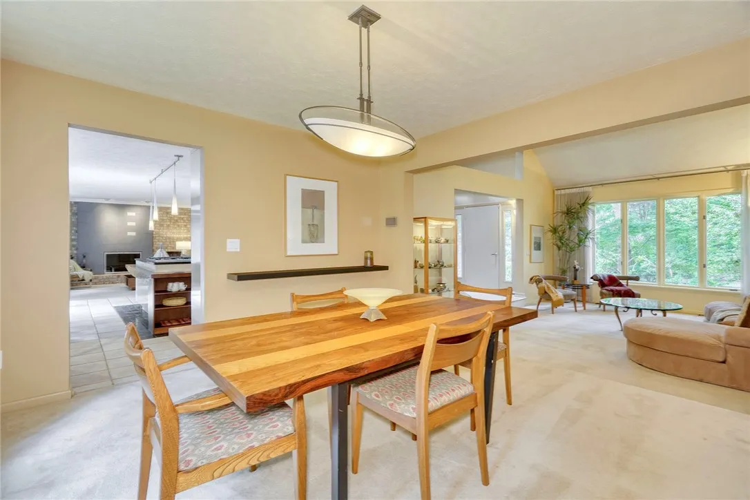 Living Room steps up to the Formal Dining Room with wall of windows overlooking the backyard!