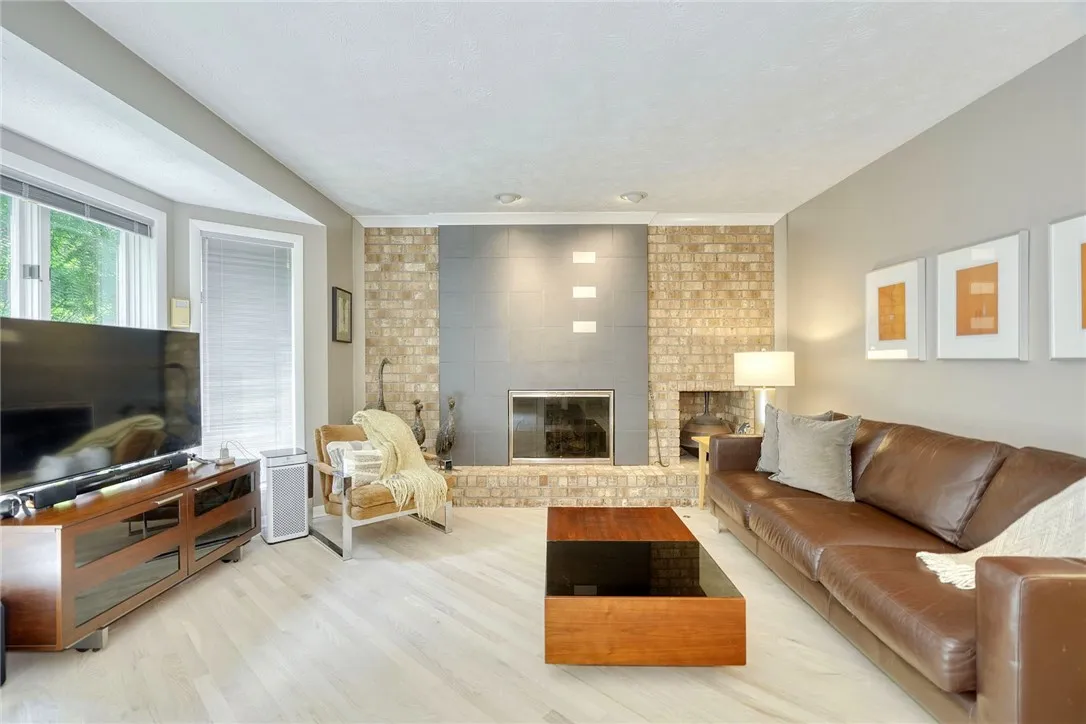 SUNLIT FAMILY ROOM with gas fireplace.