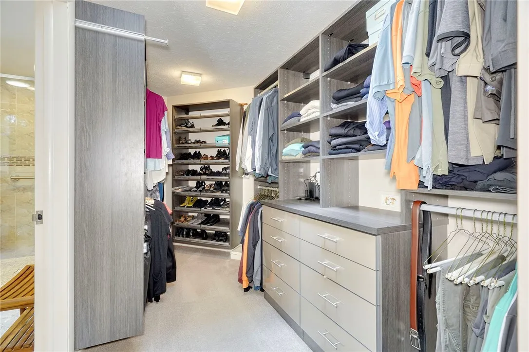 huge walk-in with California Closets custom storage!