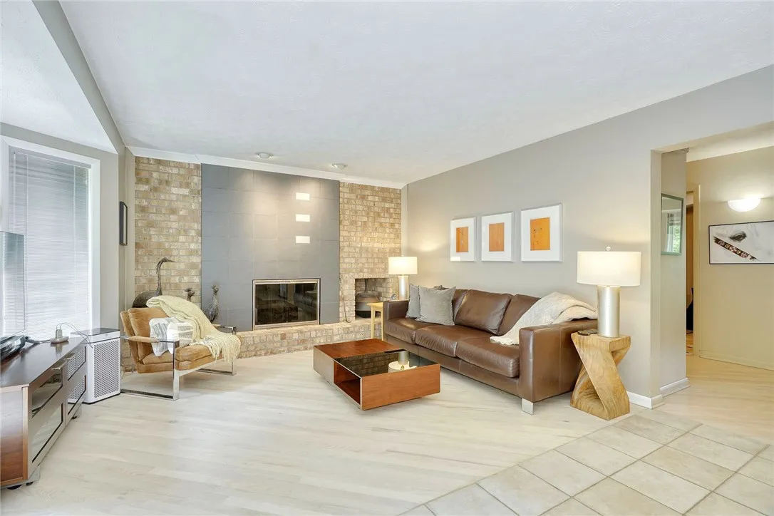 SUNLIT FAMILY ROOM with gas fireplace.