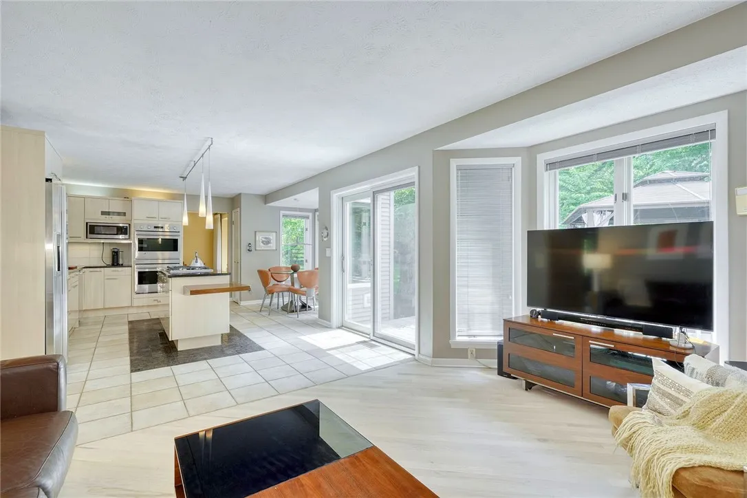 SUNLIT FAMILY ROOM with gas fireplace.