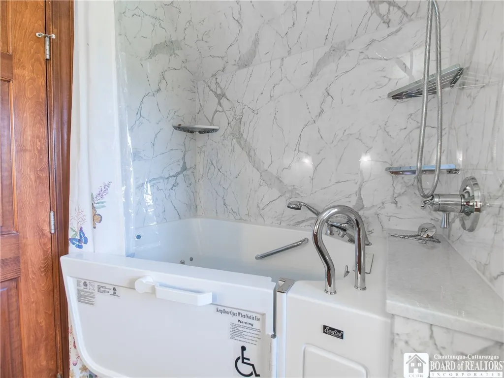 Full bathroom with walk-in tub.