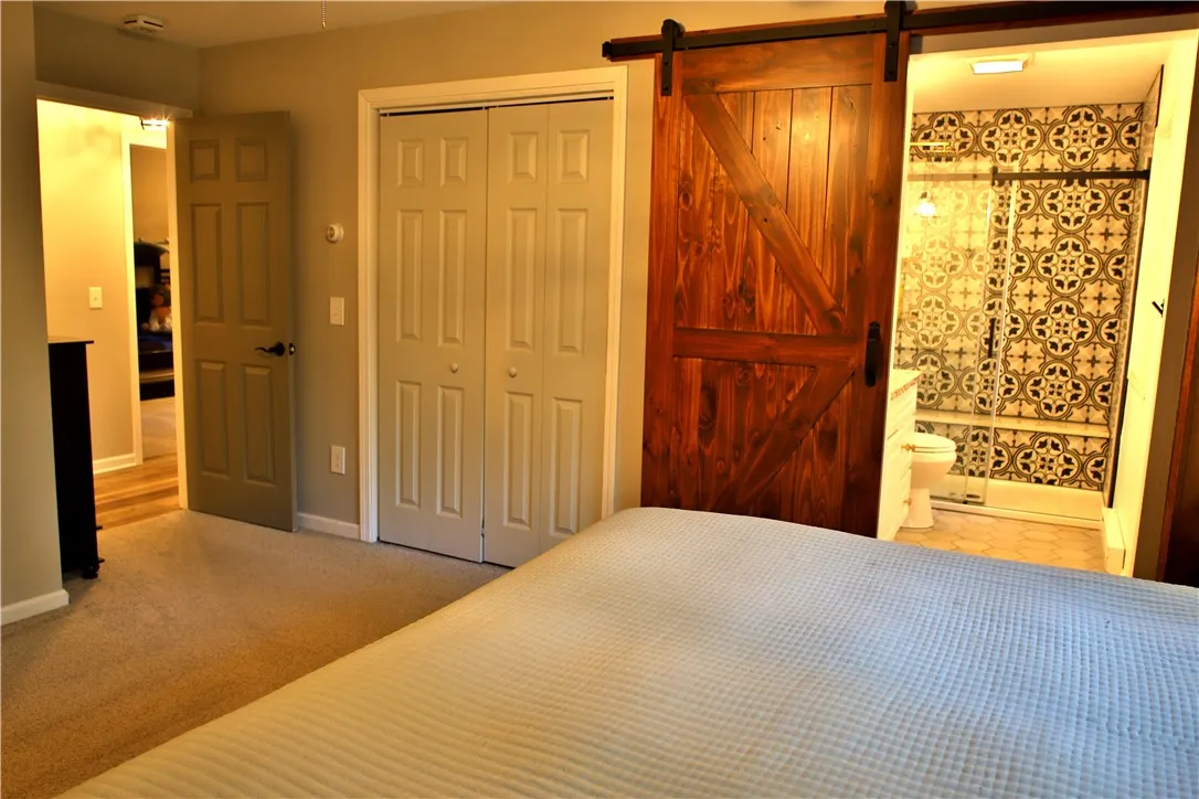 2nd view of Owner\'s suite with dual closets.