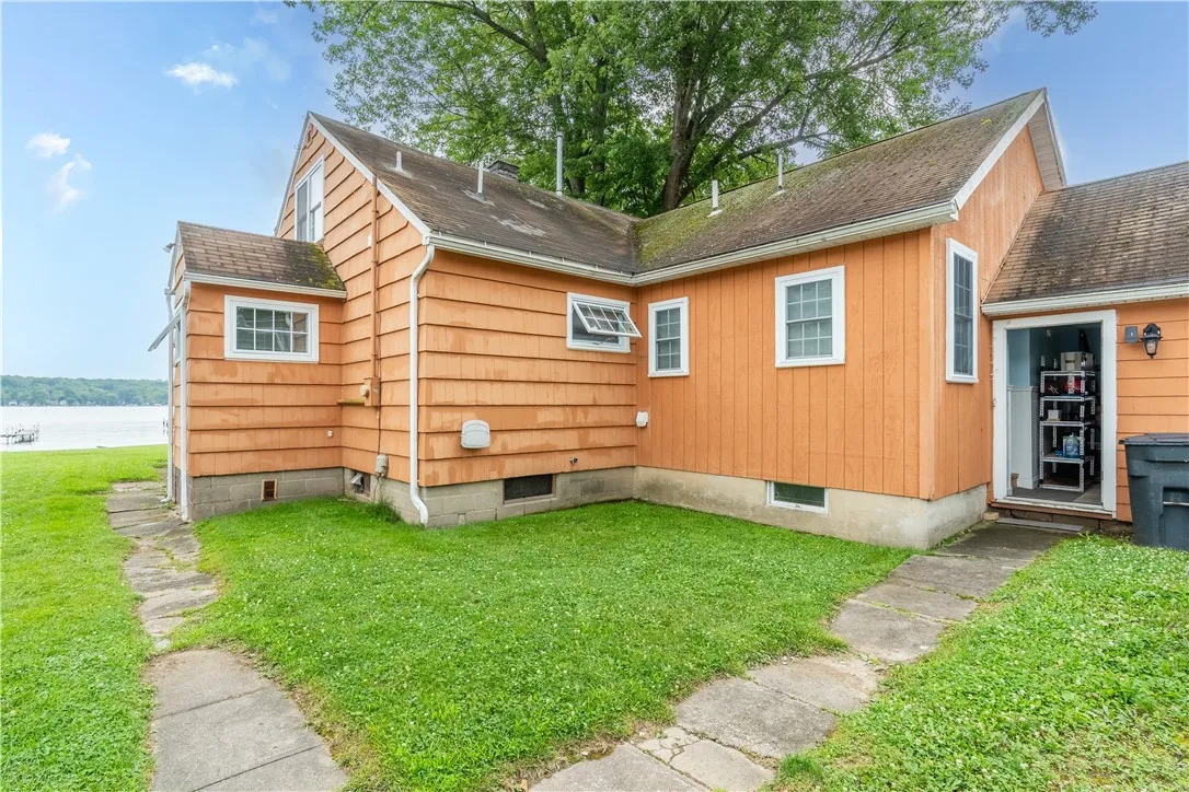 Rear entry into garage , sidewalk winding around to previous deck
