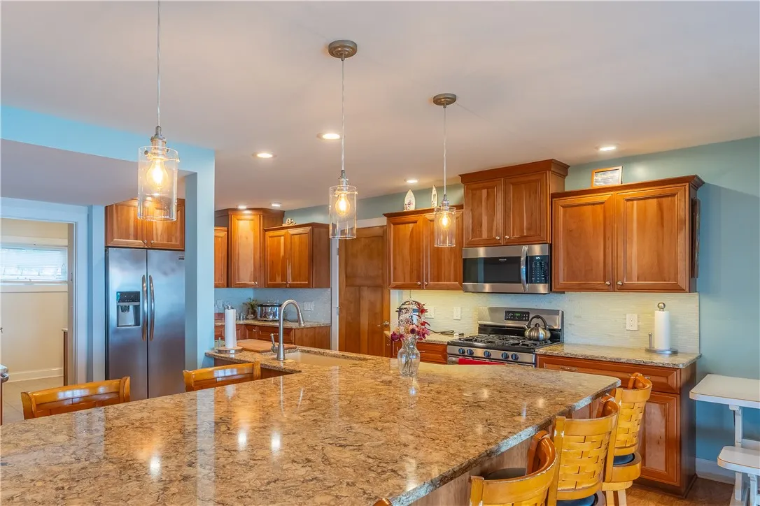 Maple cabinets, granite countertops all kitchen appliances will remain to include 2 beverage frigs