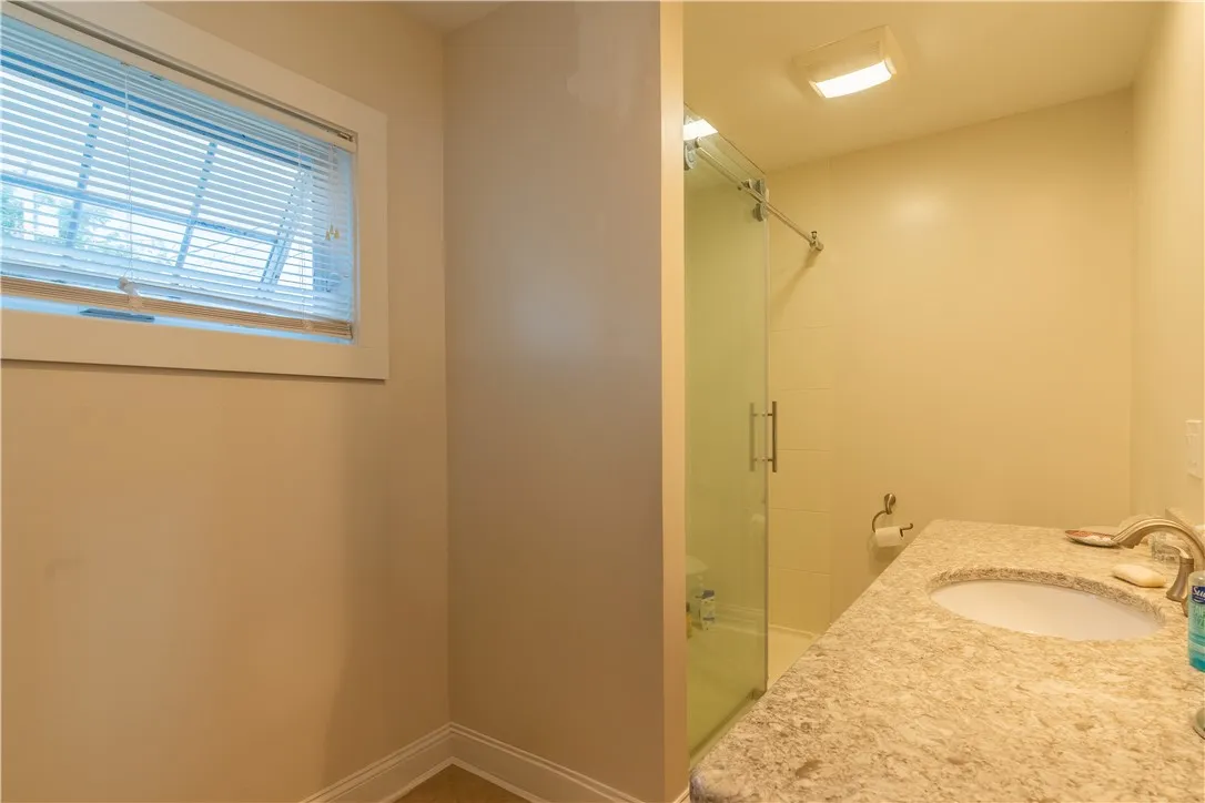 Full bath located behind the kitchen area, light and bright !