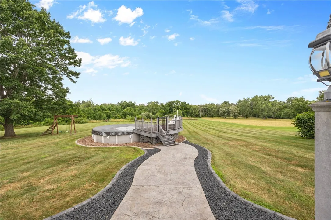 CUSTOM PROFESSIONAL STAMPED CONCRETE WALKWAY LEADING TO THE HEATED ABOVE GROUND POOL