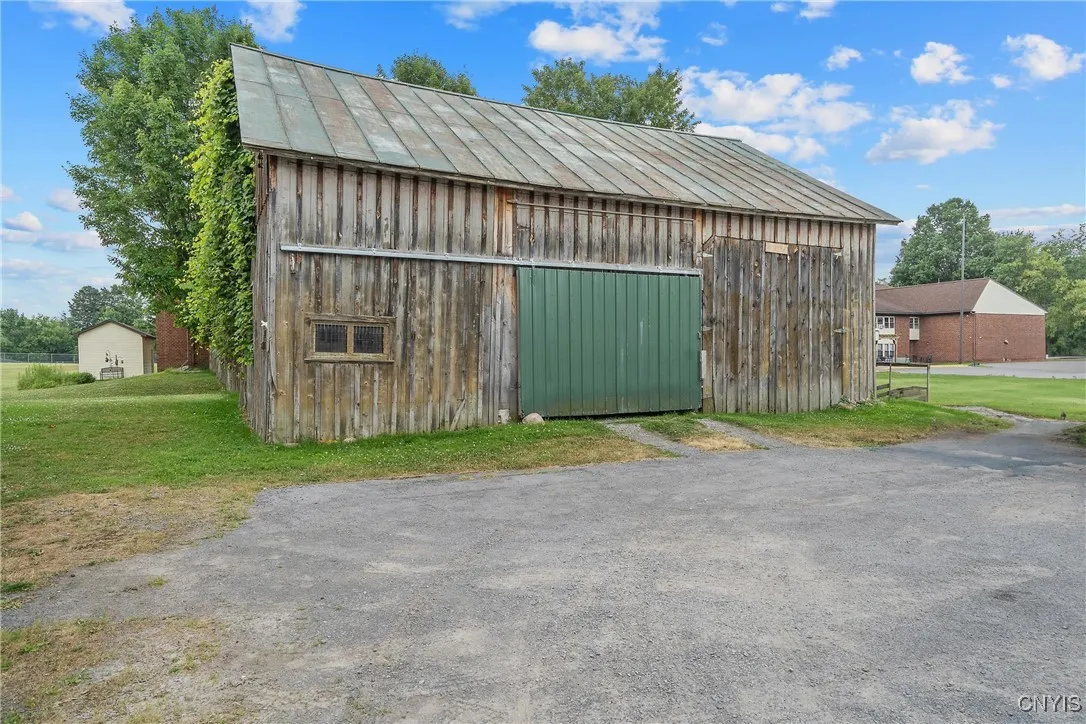 Huge barn with parking for multiple cars and storage on 2nd floor.