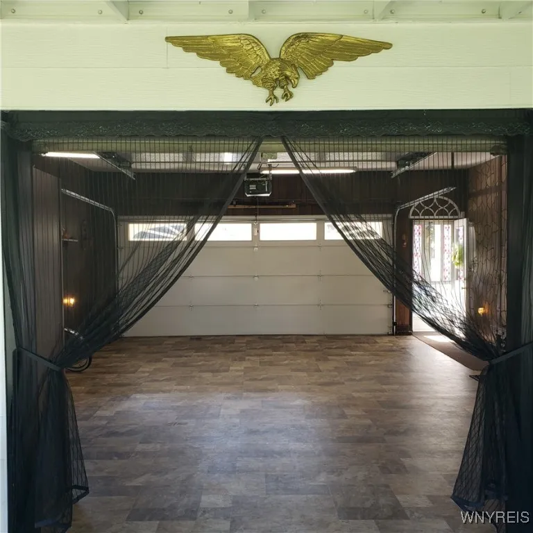 Rear door of the garage opens into the enclosed sun room