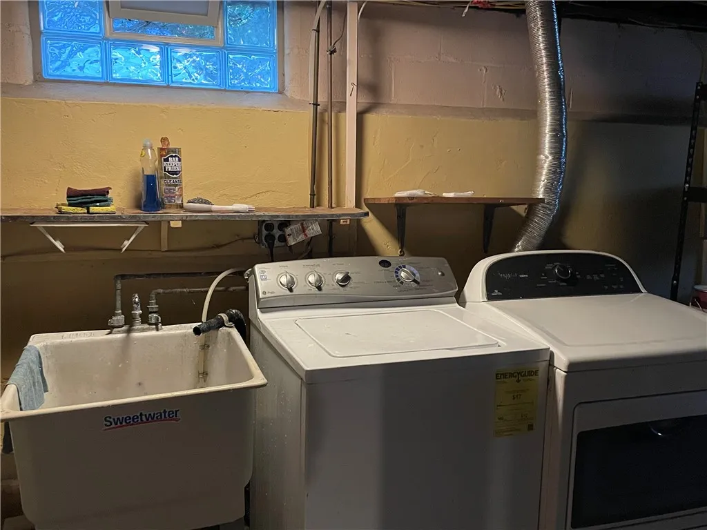 Soaking sink, washer & dryer located in the basement utility room.