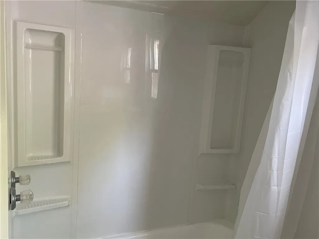 Bathtub/shower located in the upstairs bathroom.