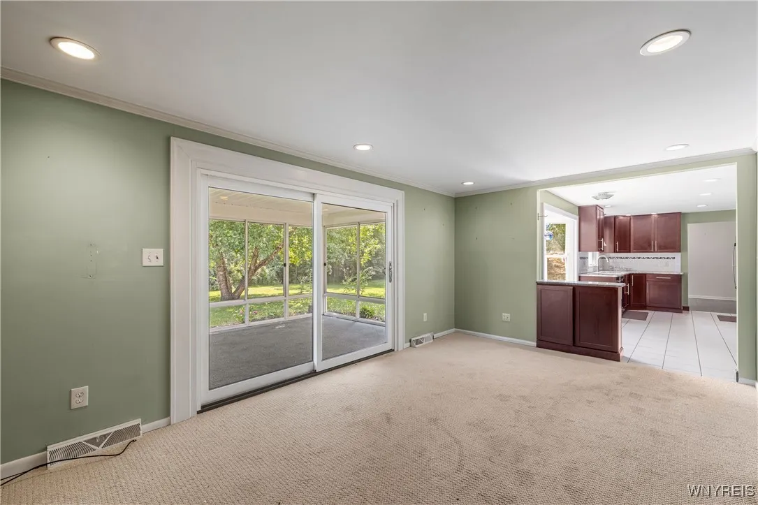 Family room leads to screened-in sunroom
