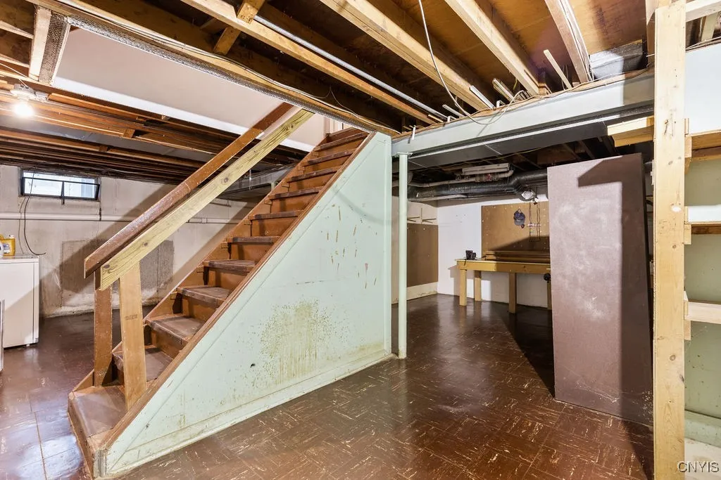 The laundry area of the basement is to the left in the photo, and the 