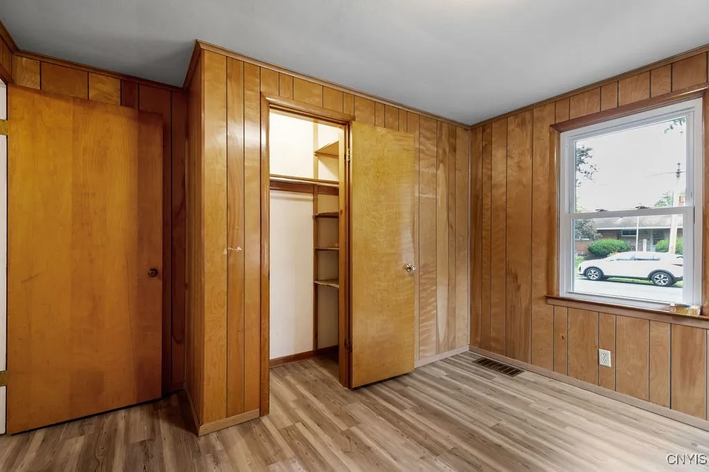 Another view of the front bedroom on the first floor shows the closet and window facing the street.