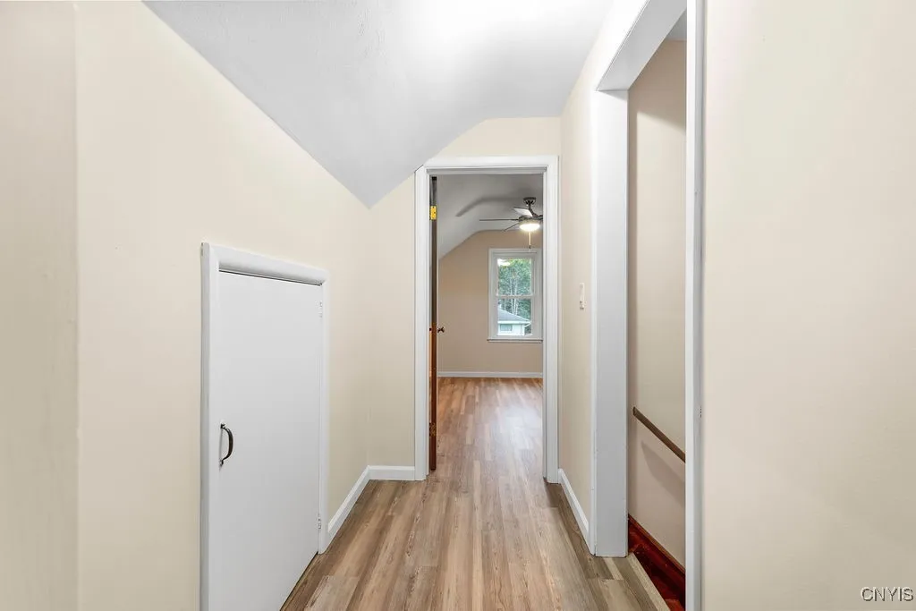 The short hallway between the two upstairs bedrooms has a small door leading to some storage space beneath the eaves of the home.