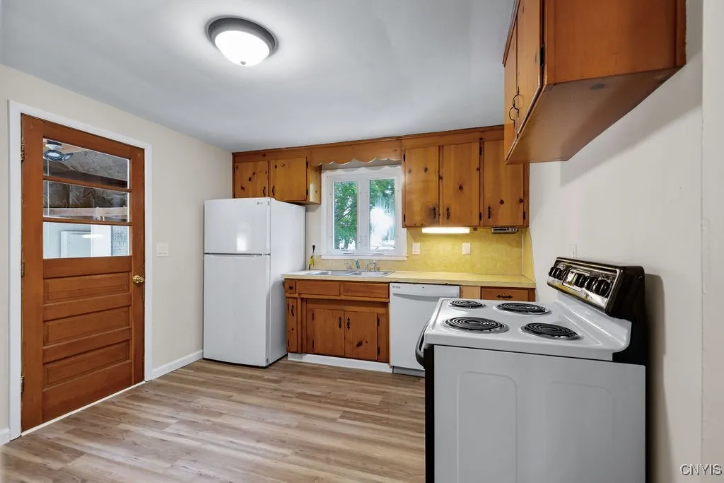 The kitchen is located at the back left hand side of the house.