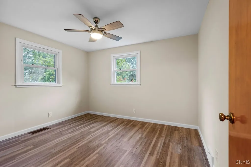 The bedroom pictured here features a new ceiling fan light combination and new luxury vinyl flooring.
