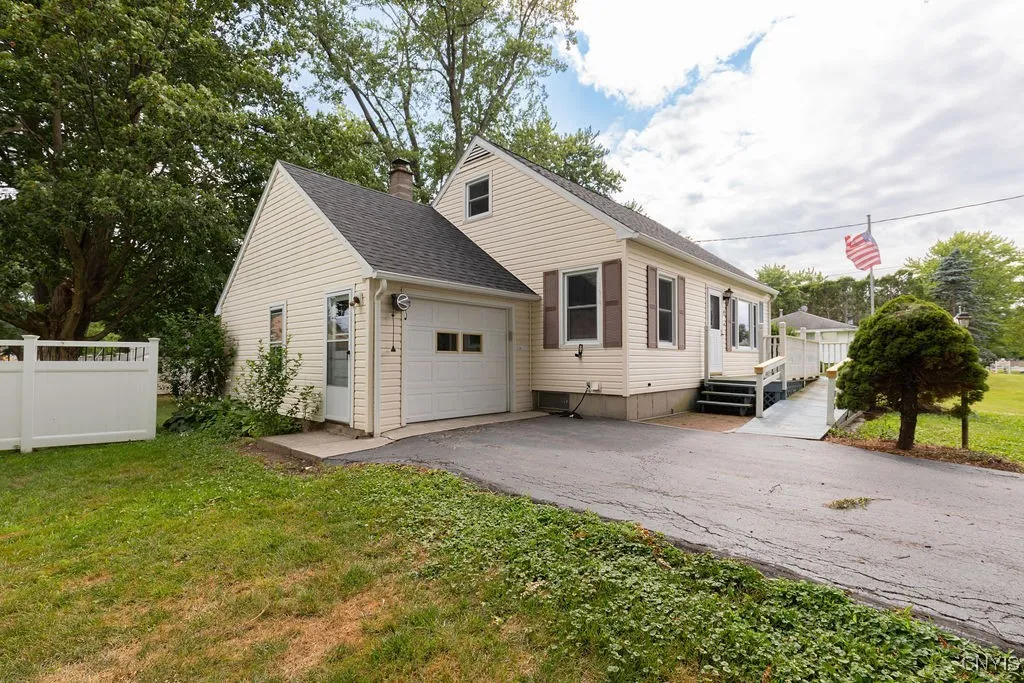 The steps to the front door are connected to the landing and ramp for access to the home.