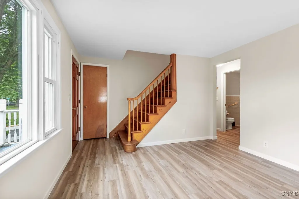 The doorway to the right in the photo leads to two first floor bedrooms, a full bath and the kitchen.