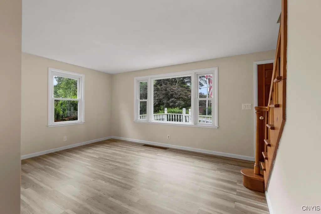 The living room is located at the front, right corner of the house and has new luxury vinyl flooring.