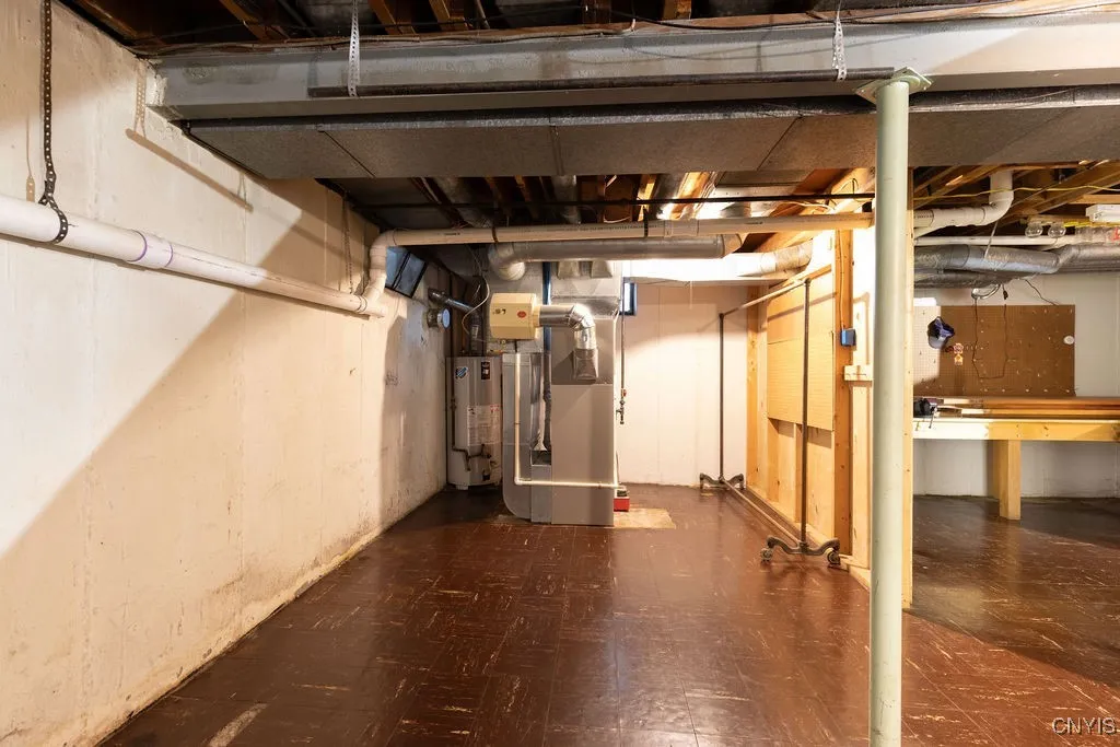 The furnace and hot water heater are on the same side of the basement as the laundry area.  They are in the back left corner of the basement. A part of the 
