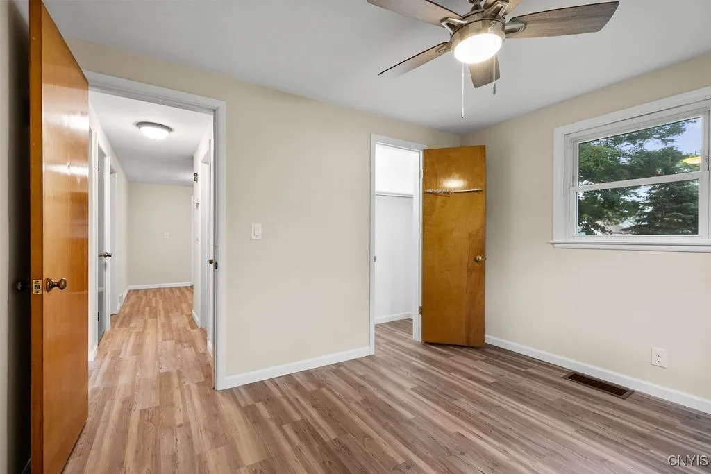 This photo shows the closet for the bedroom and hallway leading toward the kitchen, bathroom and another first floor bedroom.