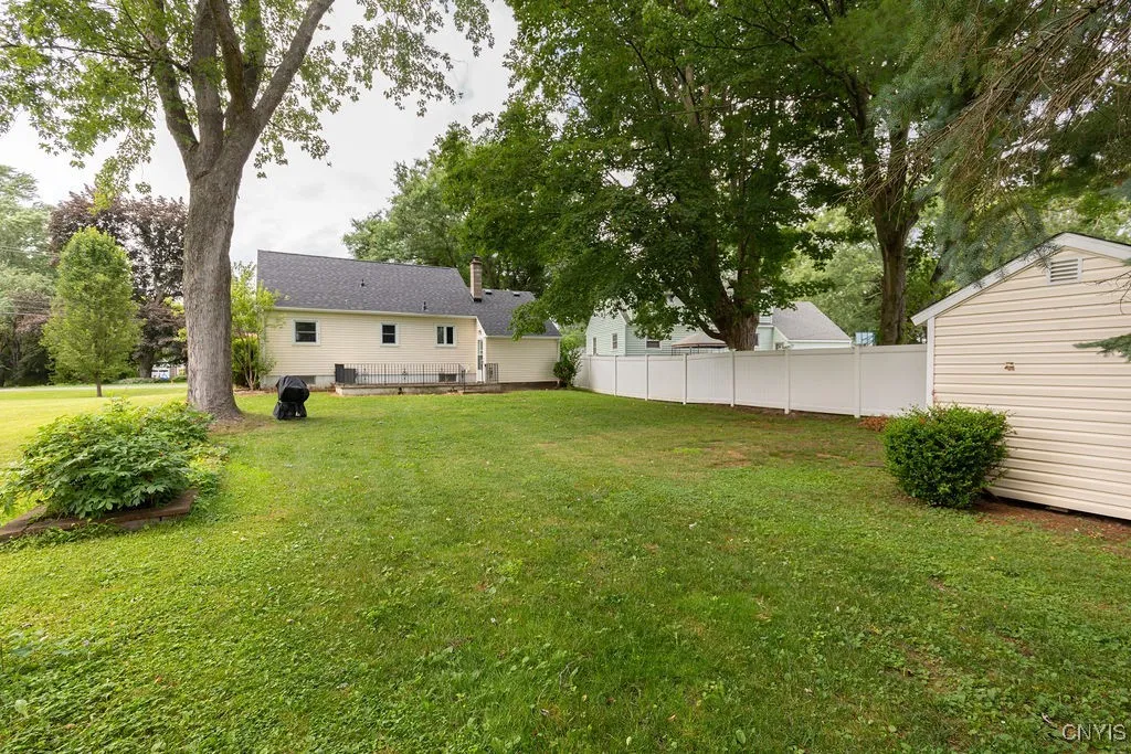 Looking at the back of the house from beyond the shed there is room for a playset, lawn games, a pool, or garden.