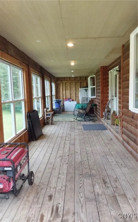 Grand front enclosed porch spans the front of the hoouse