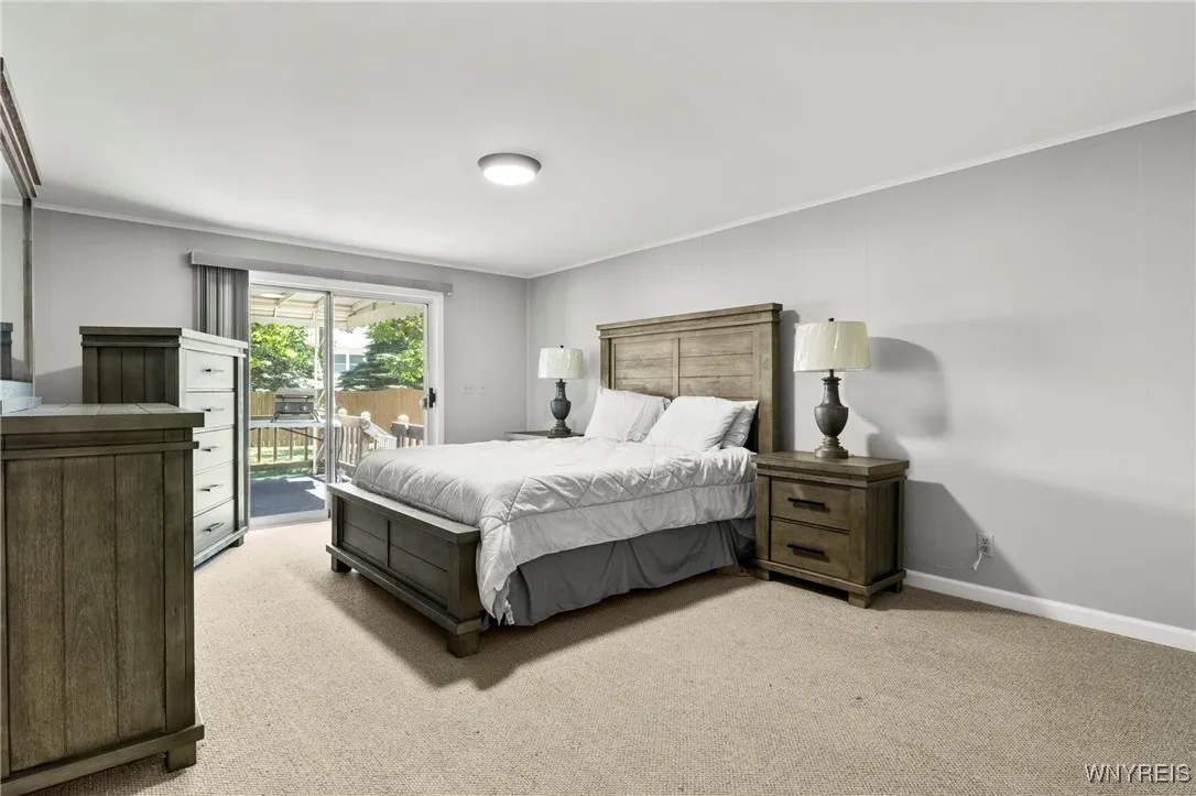 Primary Bedroom w/ Sliding Glass Doors Leading Out to Back Deck