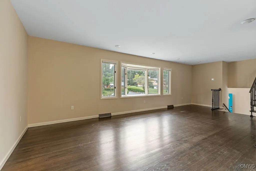 The bow window in the living room overlooks the front yard and Wedgewood Terrace.