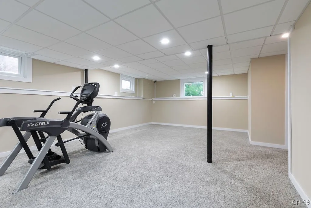 The lower level family room extends from the front of the house to the back of the house.