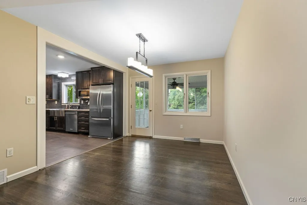 The dining room is steps away from the kitchen and from the enclosed sunporch.