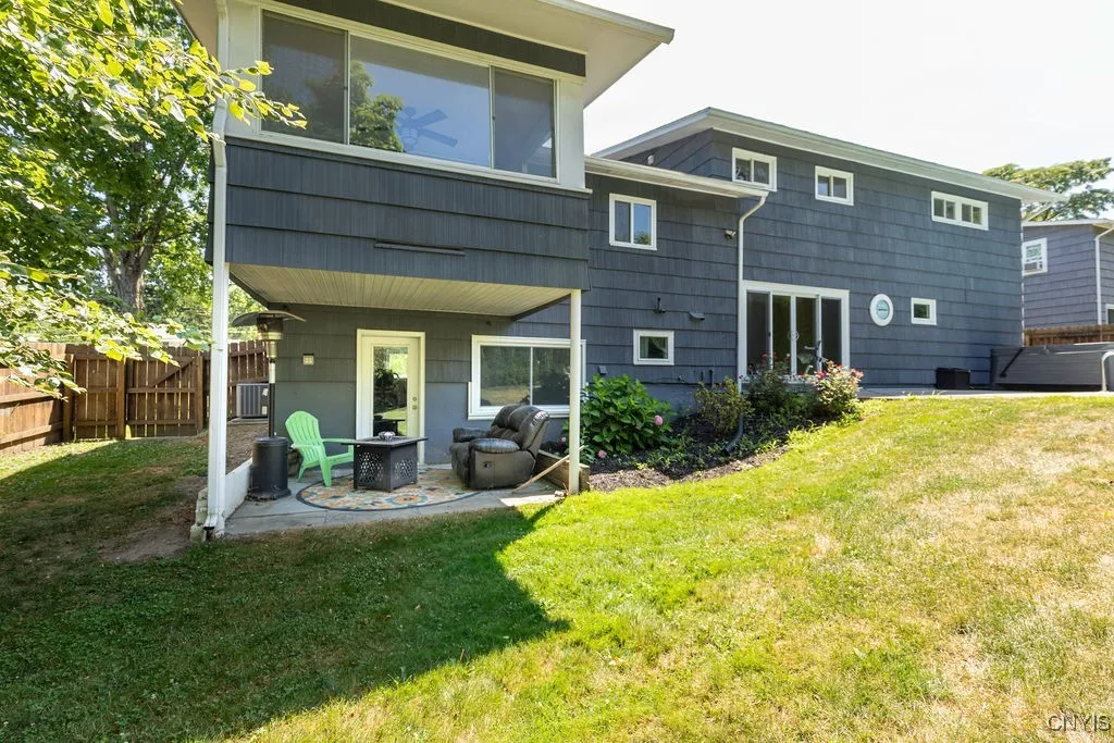 The fully fenced back yard has a gate on each side of the house.  The walk in/out door is straight ahead in the photo and leads to the lower level family room.