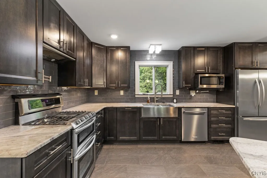 The stainless gas range, dishwasher, microwave oven and refrigerator are all included in the sale of the home.