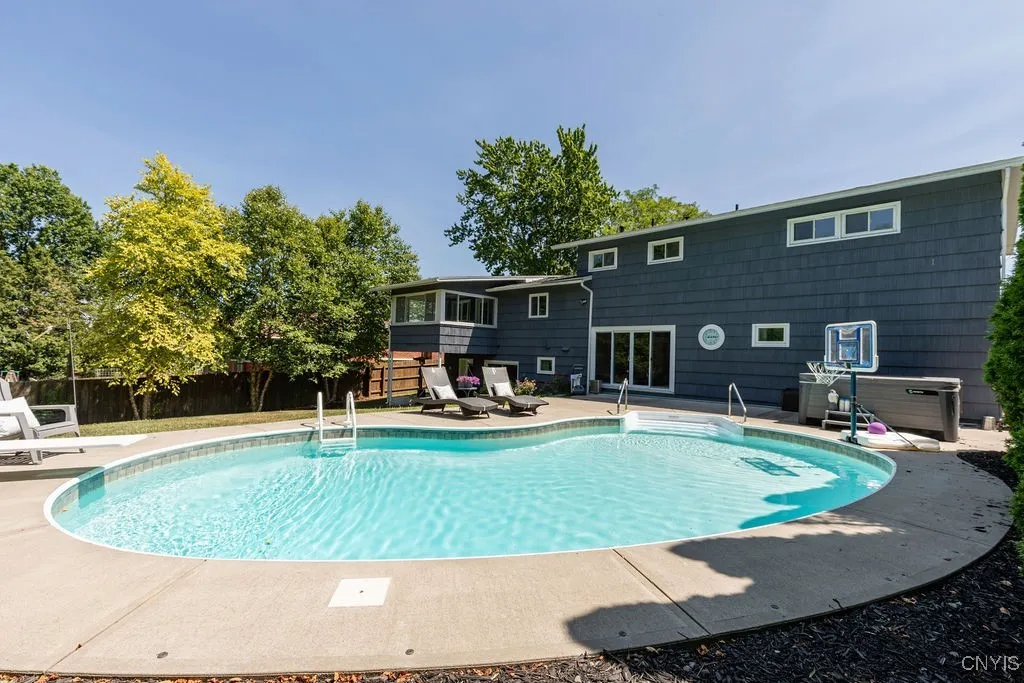 A closer look at the back yard shows access from the house through sliding glass doors.  The concrete patio has room for a table, chairs and a grill just outside those doors.