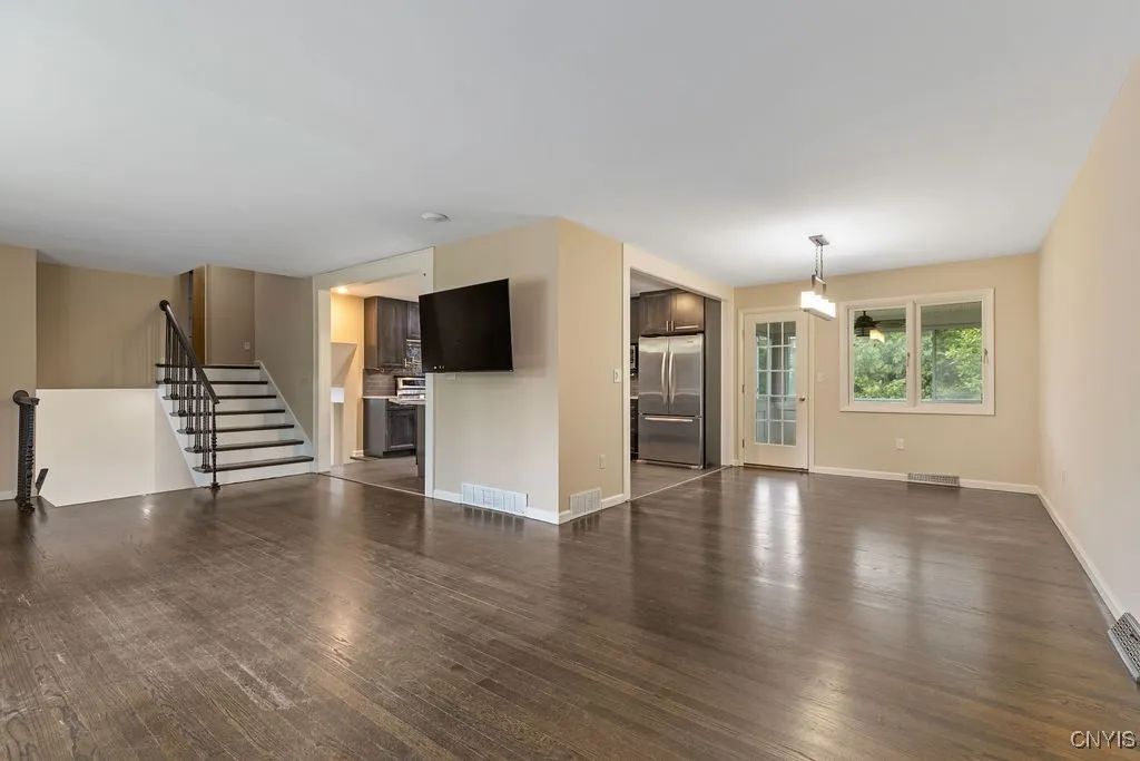 The living room and dining room wrap around the kitchen of the house in a nice, open layout.