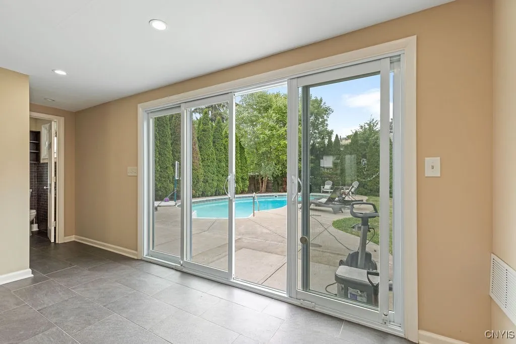 Back side of front-to -back foyer, sliders to yard, and half bath to the left in the photo.