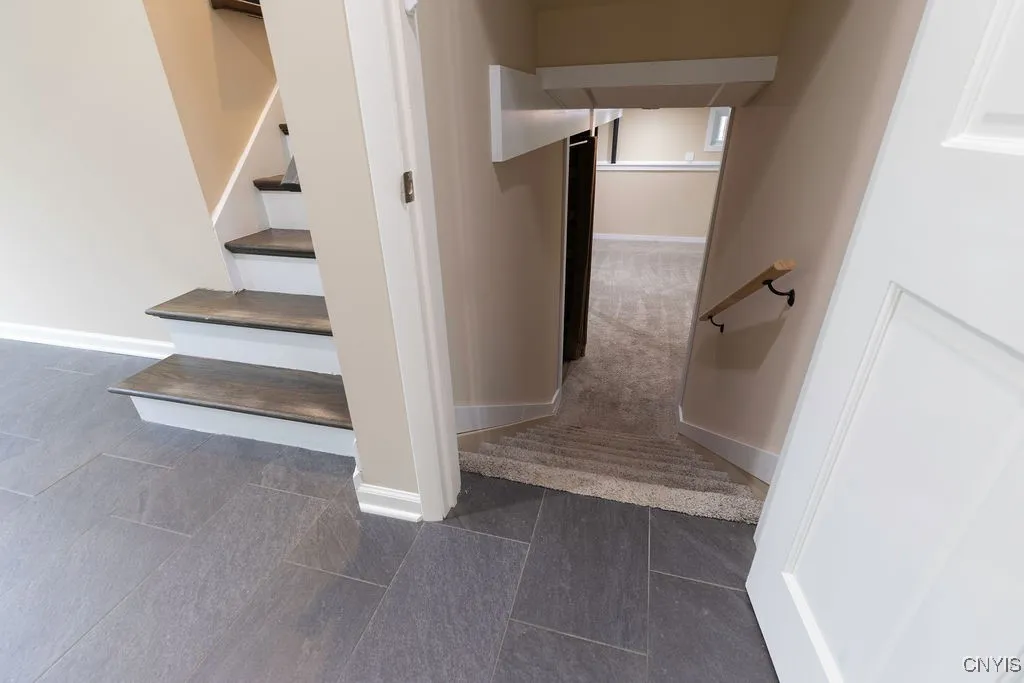 This is truly a split level with separate spaces for  activities and people.  The right hand stairs lead to the front-to-back family room with new carpet and paint.  The laundry area and walk out door to the back yard are also in this lower level.  To the left, the stairs lead up to the kitchen.