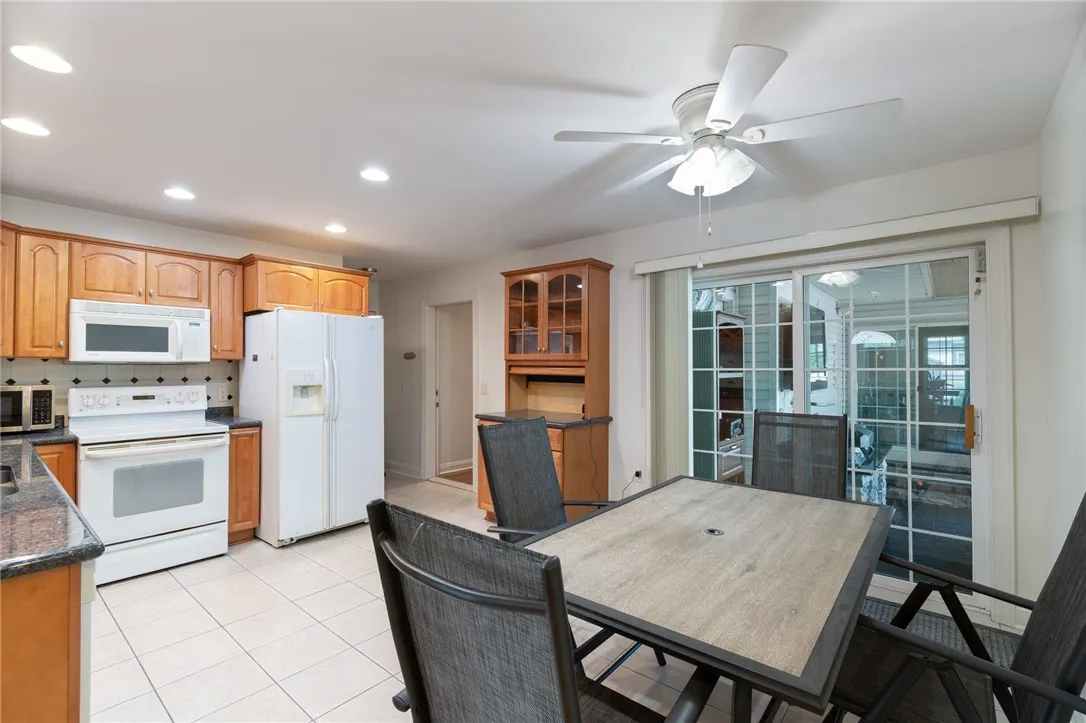 The FIRST FLOOR IN LAW with its own patio doors that open to the pool/outdoor kitchen and even has its own covered porch!