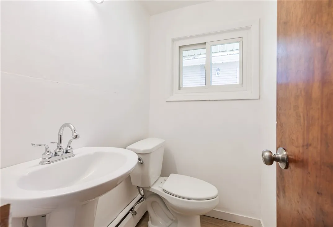 half bath off the kitchen and next to the mudroom/laundry room.