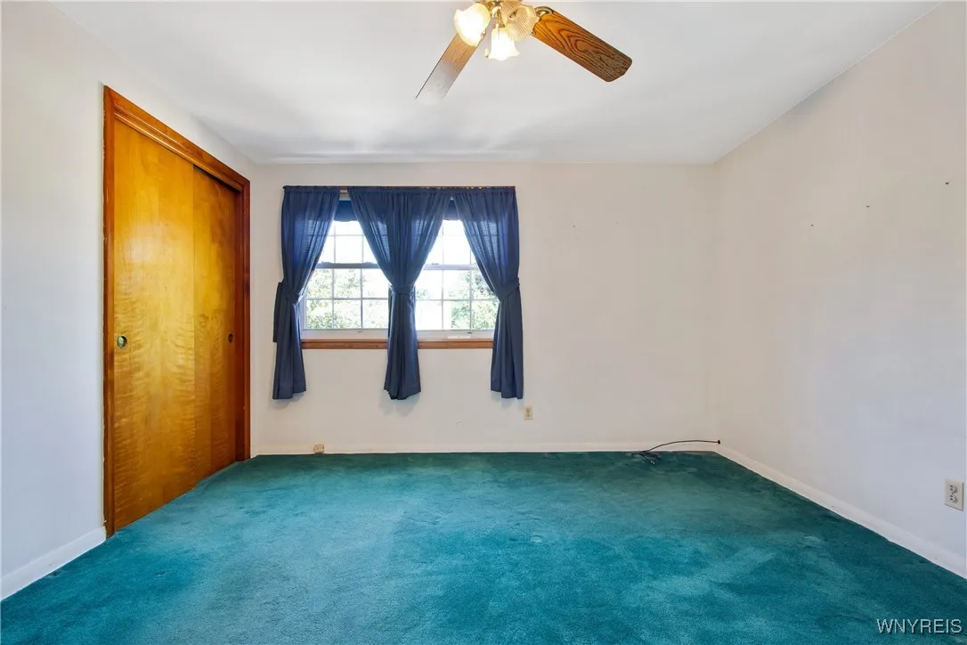 bedroom(to left of stairway) hardwood beneath carpet