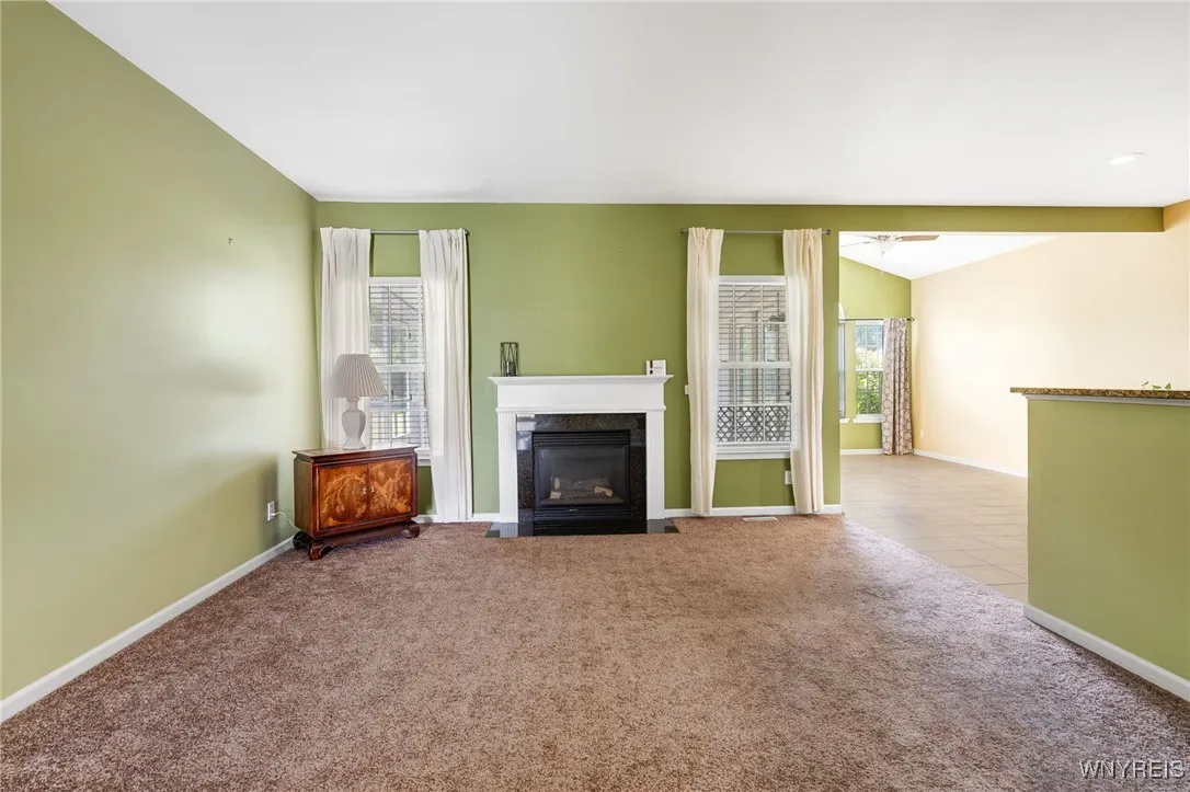 Gas fireplace with windows the view the yard.