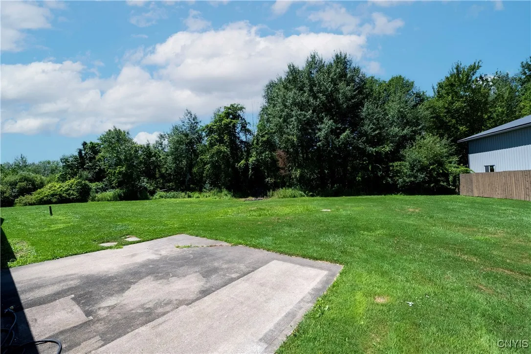 Patio off the back is perfect to enjoy summer parties!  Lush, flat lawn is easy to maintain.  Add a pool, playground or whatever fits your needs in the oversized yard!