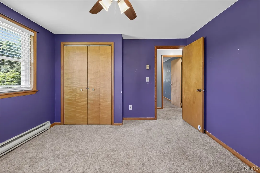 The second bedroom has plush carpeting and an adorable view.  Generous closet space awaits!
