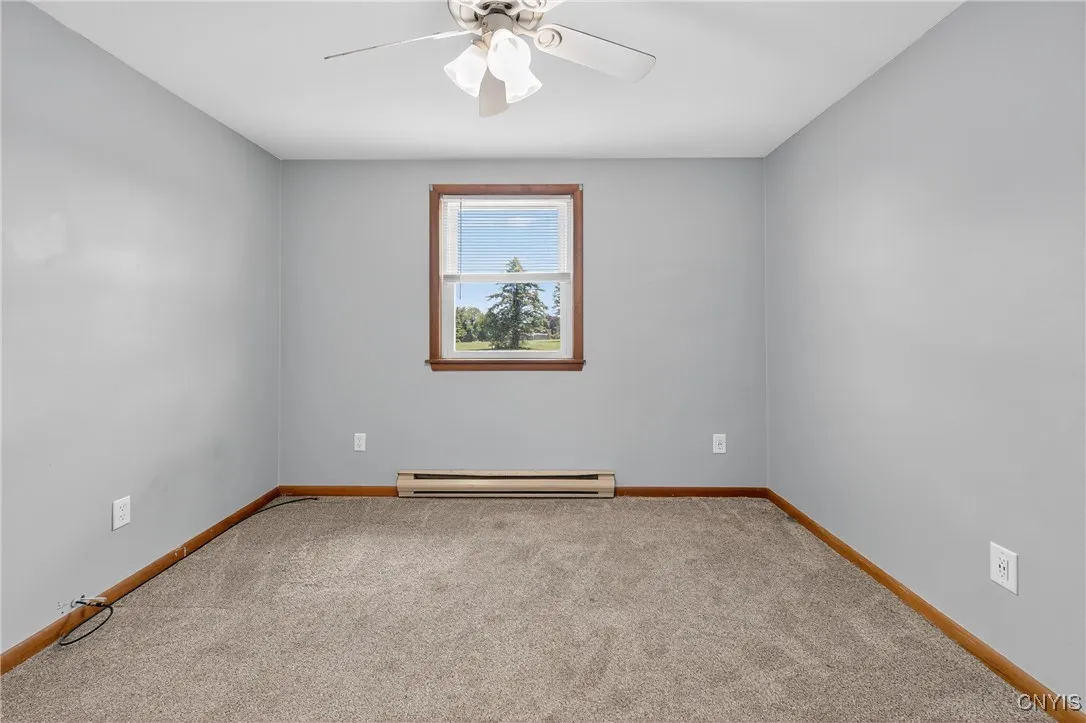 Third bedroom is spacious!  Enjoy a ceiling fan for the warmer nights, and cozy, neutral carpeting.