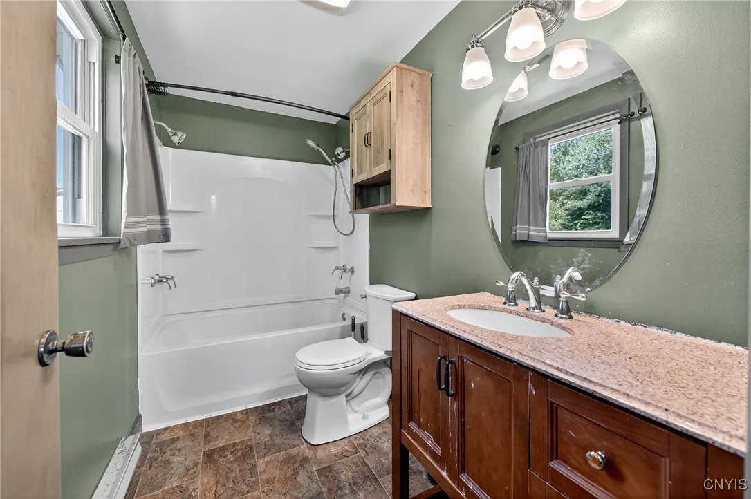 Enjoy a spacious full bath in the primary bedroom, complete with a beautiful tub surround, modern lighting, and nicely sized vanity.
