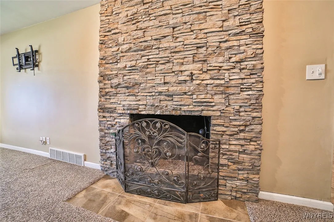 Nice gas fireplace with great floor to ceiling stonework