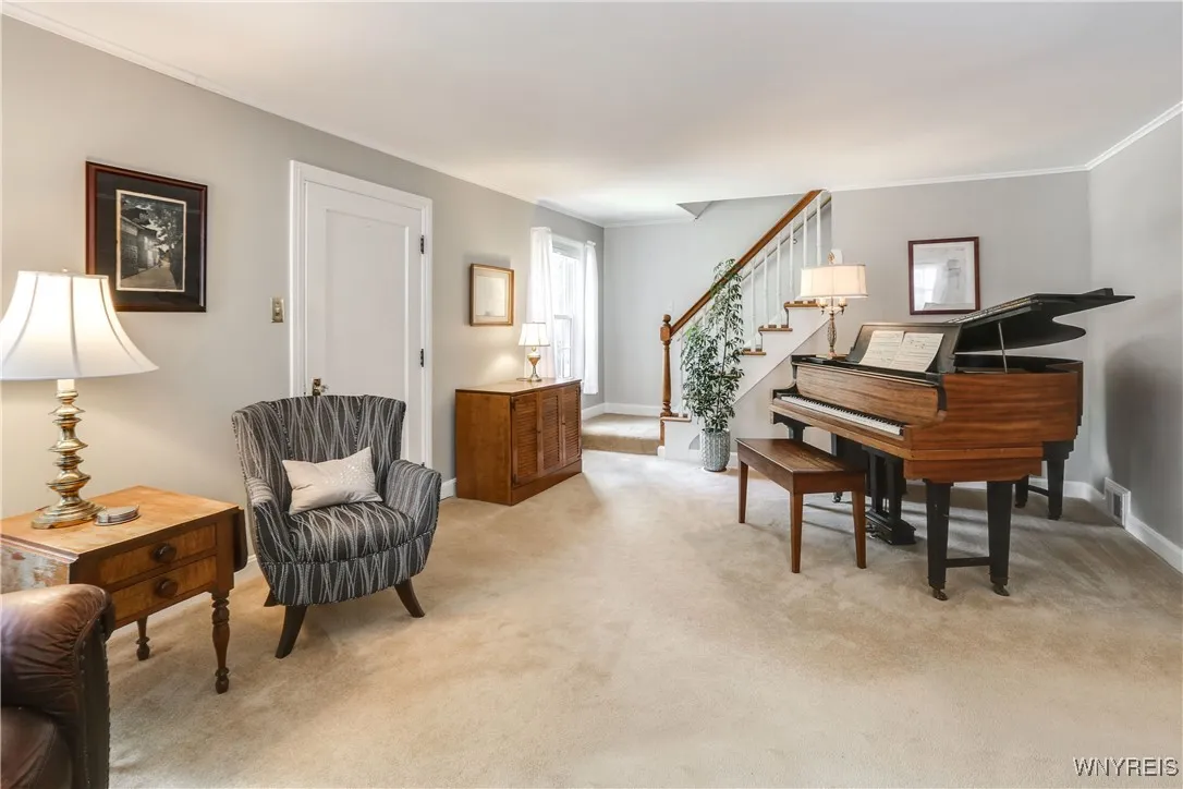 Living room facing the staircase for 2nd floor.  w/w carpet but there are hardwood floors underneath.